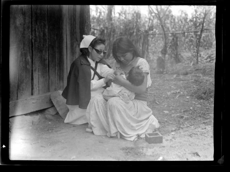 A nurse working with a young indigenous woman